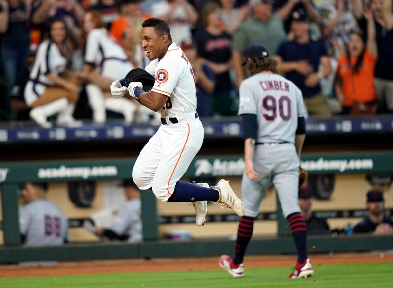 Houston Astros' Tony Kemp, left, celebrates after hitting the game-winning home run as Cleveland Indians relief pitcher Adam Cimber (90) walks to the dugout during the 10th inning of a baseball game Saturday, April 27, 2019, in Houston. The Astros won 4-3