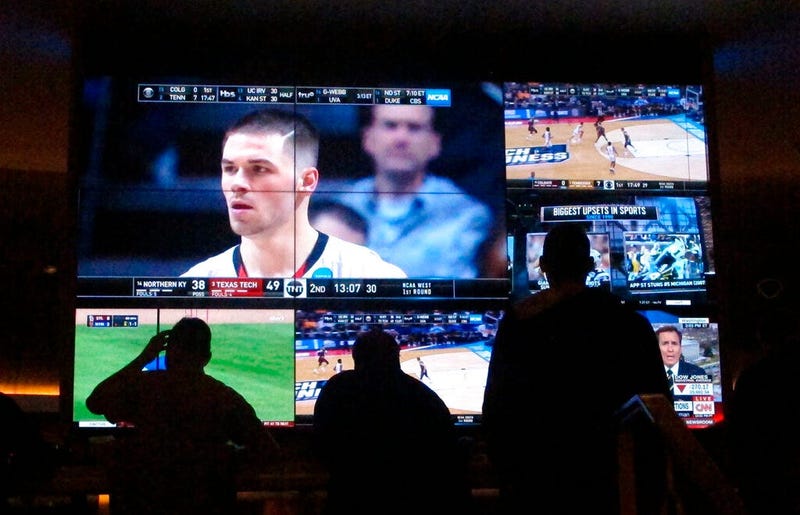 customers watch a game during the NCAA March Madness college basketball tournament at the Hard Rock casino in Atlantic City N.J. Casinos in eight states are opening or expanding retail sportsbooks to capture in-person sports betting business, even while m