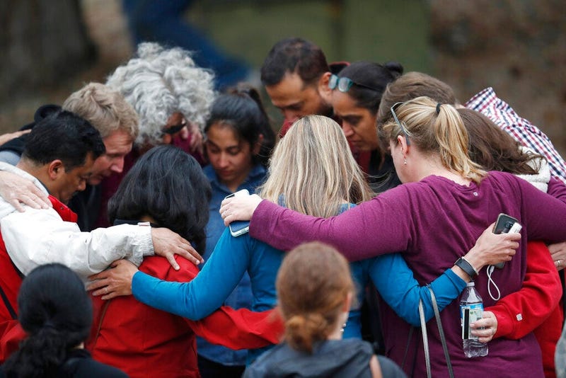 Parents gather in a circle to pray at a recreation center where students were reunited with their parents after a shooting at a suburban Denver middle school Tuesday, May 7, 2019, in Highlands Ranch, Colo.
