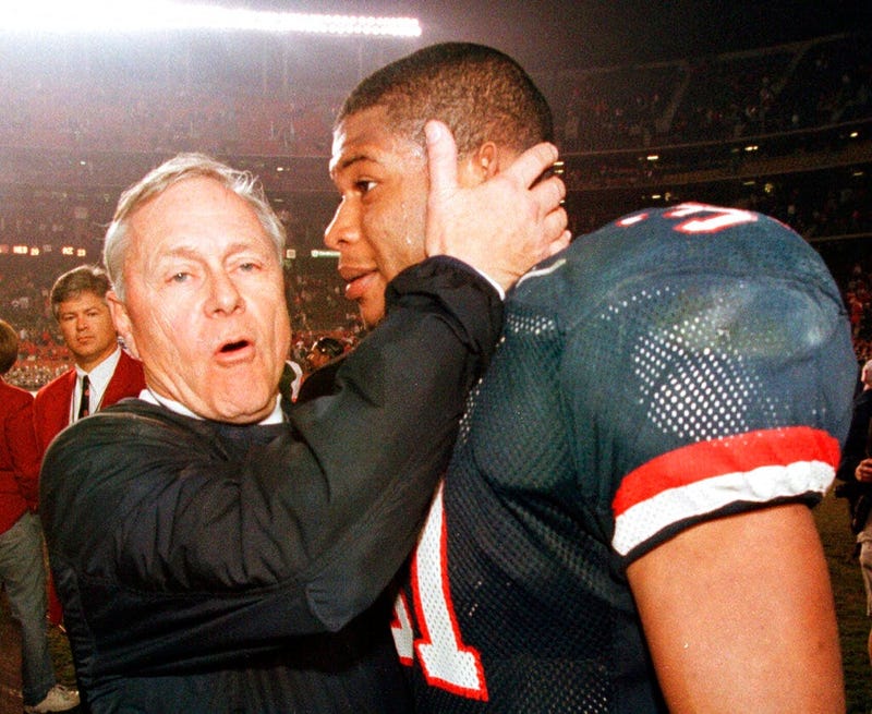 Arizona coach Dick Tomey, left, congratulates linebacker DaShon Polk after the Wildcats 23-20 win over Nebraska in the Holiday Bowl NCAA college football game in San Diego. Tomey, the winningest football coach in University of Arizona history, died Friday