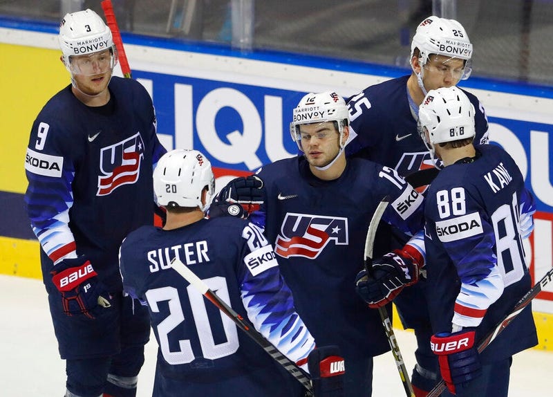 Patrick Kane of the US, left, scores his sides fifth goal past Sebastian Ylonen of France, right, and Jonathan Janil of France, center, during the Ice Hockey World Championships group A match between the United States and France at the Steel Arena in Kosi