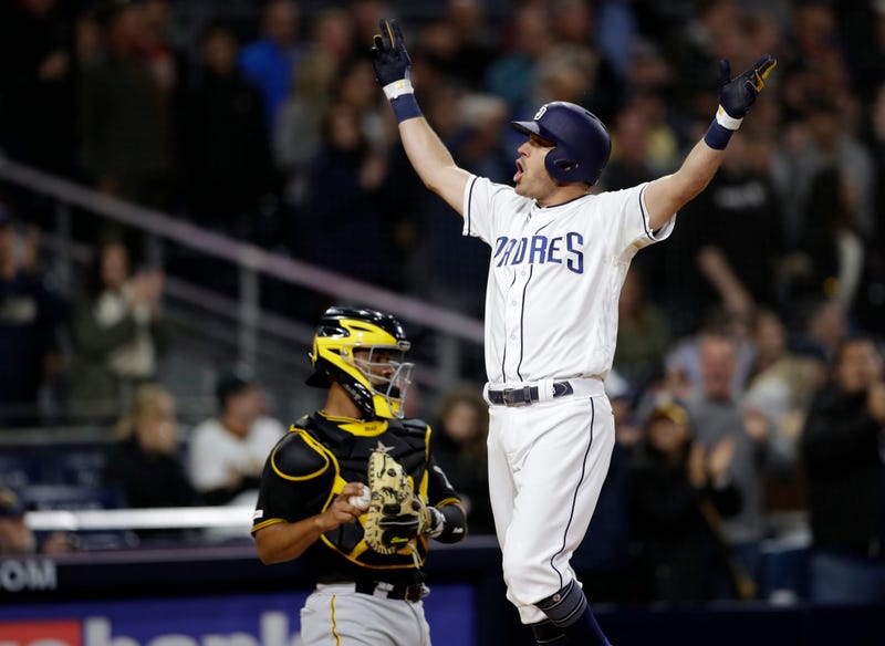 San Diego Padres' Ian Kinsler celebrates after hitting a three-run home run, next to Pittsburgh Pirates catcher Elias Diaz during the sixth inning of a baseball game Thursday, May 16, 2019, in San Diego