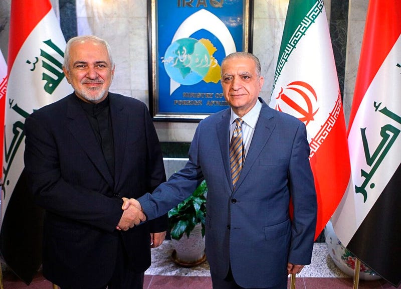 Iraqi Foreign Minister Mohamed Alhakim, right, shakes hands with his visiting Iranian counterpart Mohammad Javad Zarif at the Ministry of Foreign Affairs Building in Baghdad, Iraq, Sunday, May 26, 2019