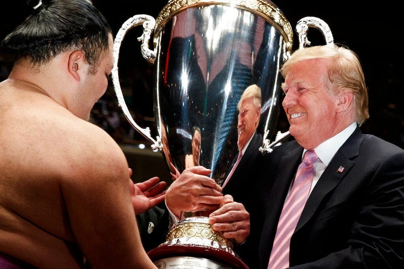President Donald Trump presents the "President's Cup" to Tokyo Grand Sumo Tournament winner Asanoyama, at Ryogoku Kokugikan Stadium, Sunday, May 26, 2019, in Tokyo.