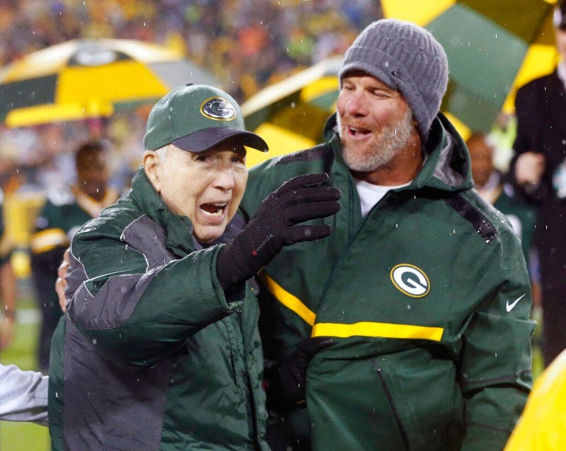 Brett Favre, right, smiles at Bart Starr during a ceremony at halftime of an NFL football game