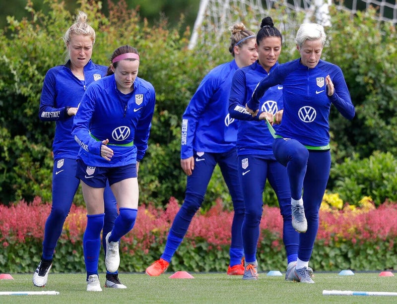US player Megan Rapinoe, front right, stretches with Ali Krieger and other team members during a US womens soccer team training session at the Tottenham Hotspur training centre in London, Thursday, June 6, 2019. The Women's World Cup starts in France on J