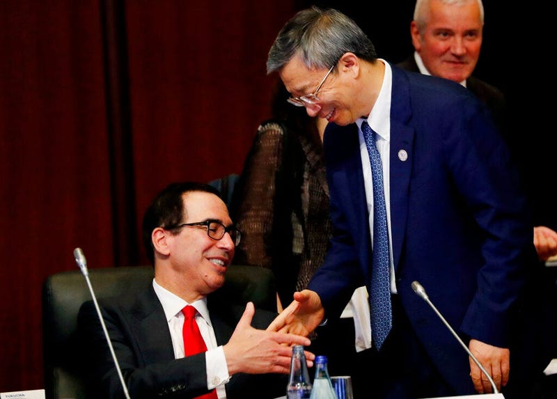 China's Central Bank Governor Yi Gang shakes hands with U.S. Treasury Secretary Steve Mnuchin, left, during the G20 Finance Ministers and Central Bank Governors Meeting Saturday, June 8, 2019, In Fukuoka, Japan.