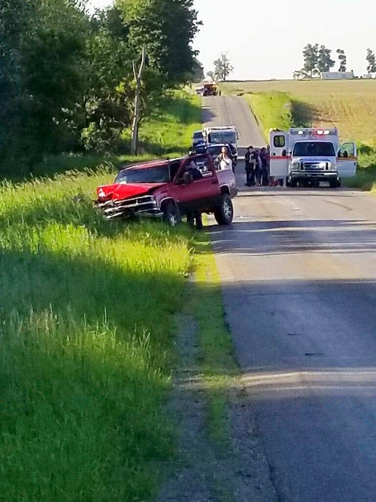 A damaged truck sits on the side of the road after an accident involving a horse-drawn carriage on Friday, June 7, 2019