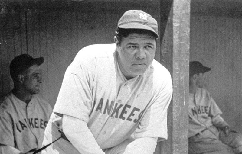 New York Yankees' Babe Ruth, who was injured, stands in the dugout during the baseball team's game at Cleveland