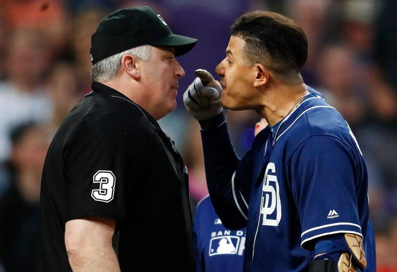 San Diego Padres shortstop Manny Machado, right, yells at home plate umpire Bill Welke, who had called Machado out on strikes during the fifth inning of the team's baseball game against the Colorado Rockies on Saturday, June 15, 2019, in Denver.