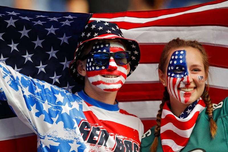 Austin, left, and Jordyn Chambers, from Philadelphia, hold up an US flag prior the Women's World Cup Group F soccer match between United States and Chile at Parc des Princes in Paris, France, Sunday, June 16, 2019.