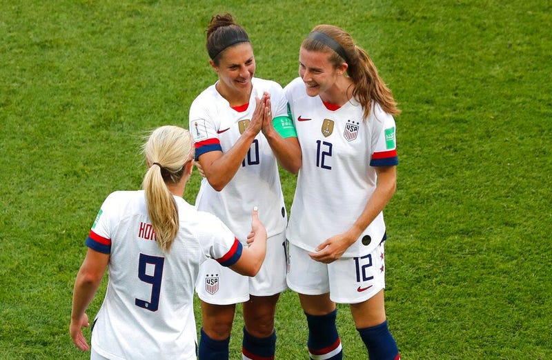 United States' Carli Lloyd , center, celebrates with Lindsey Horan and Tierna Davidson, right, after scoring the opening goal during the Women's World Cup Group F soccer match between the United States and Chile at the Parc des Princes in Paris, Sunday, J