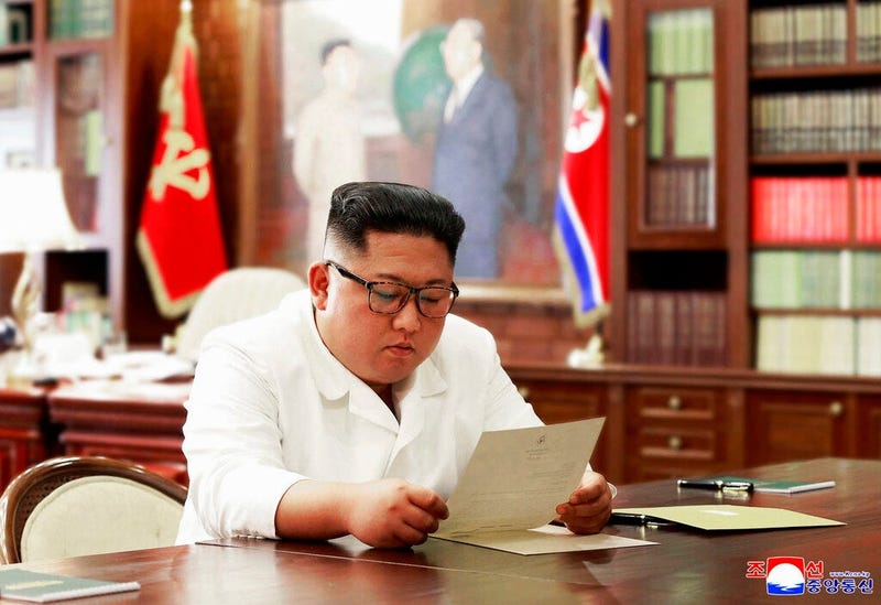 North Korean leader Kim Jong Un reads a letter from U.S. President Donald Trump