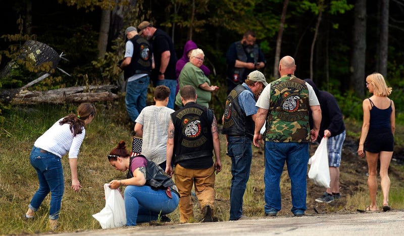 People recover personal items from the scene of a fatal accident on Route 2 in Randolph, N.H., Saturday, June 22, 2019. Investigators pleaded Saturday for members of the public to come forward with information that could help them determine why a pickup t