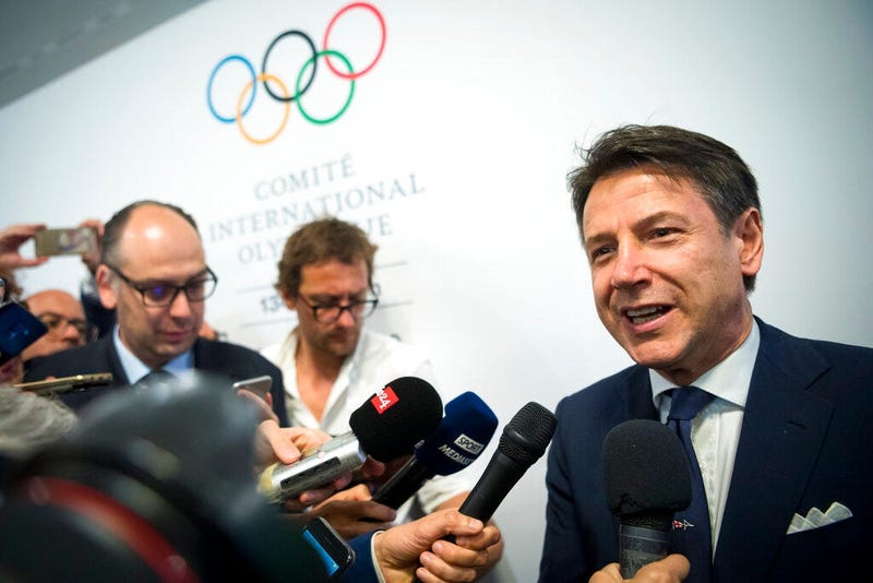 Italian Prime minister Giuseppe Conte speaks to journalists as he arrives during the first day of the 134th Session of the International Olympic Committee 