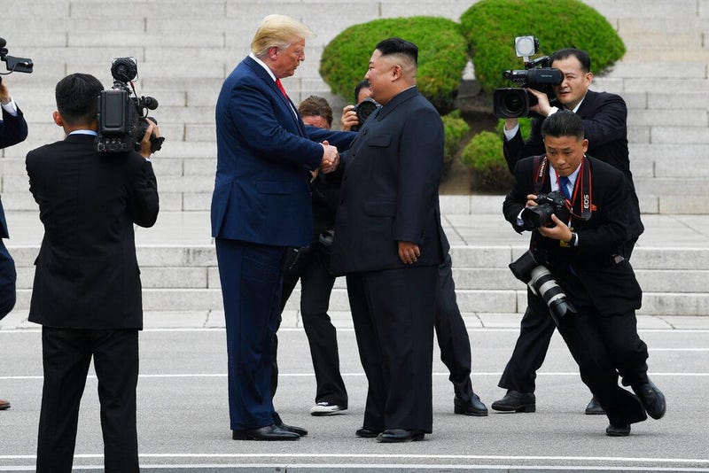 President Donald Trump walks to the North Korean side of the border with North Korean leader Kim Jong Un at the border village of Panmunjom in the Demilitarized Zone, Sunday, June 30, 2019, in North Korea.