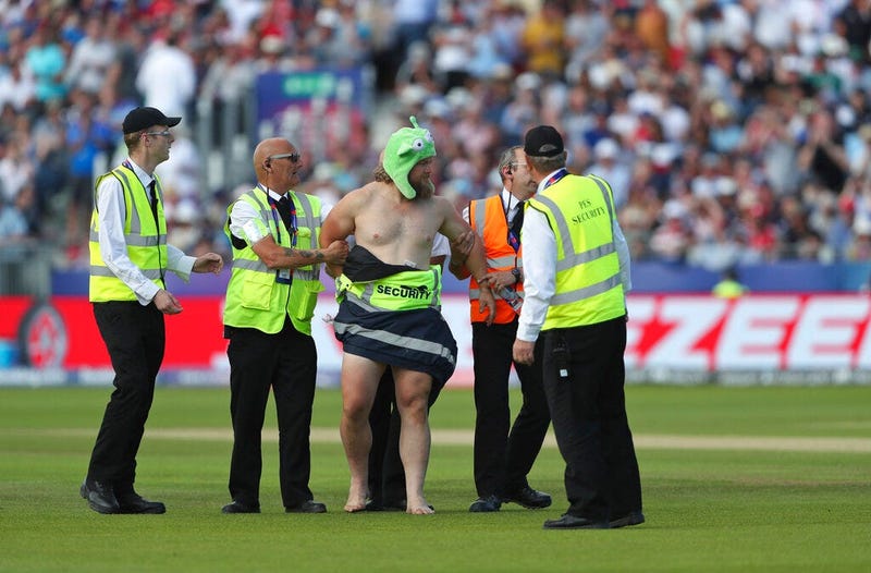 A streaker runs into the field during the Cricket World Cup match between New Zealand and England in Chester-le-Street, England, Wednesday, July 3, 2019.