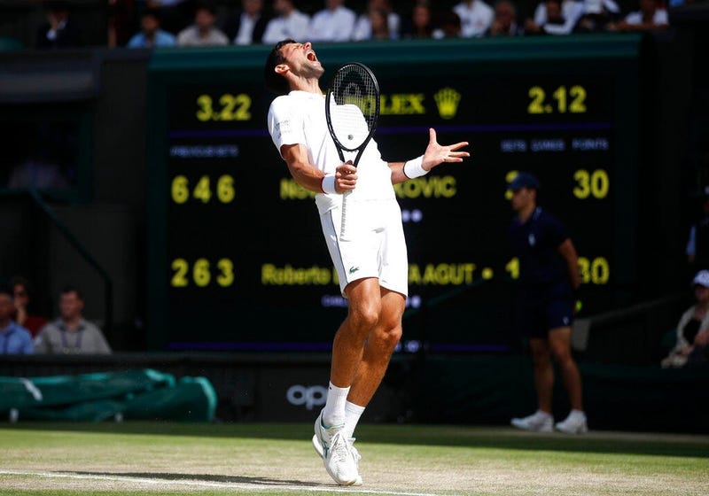Serbia's Novak Djokovic reacts as he plays against Spain's Roberto Bautista Agut in a Men's singles semifinal match on day eleven of the Wimbledon Tennis Championships in London, Friday, July 12, 2019.