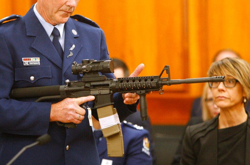 Police Sr. Sgt. Paddy Hannan shows New Zealand lawmakers an AR-15 style rifle 
