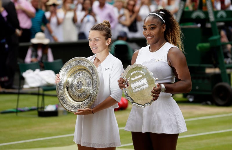 Winner Romania's Simona Halep and second placed United States' Serena Williams, right, pose with their trophies after the women's singles final match on day twelve of the Wimbledon Tennis Championships in London, Saturday, July 13, 2019.