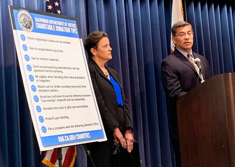 California Attorney General Xavier Becerra, right, and senior Assistant Attorney Genera Tania Ibanez announce a lawsuit the state has filed alleging misdeeds by Move America Forward