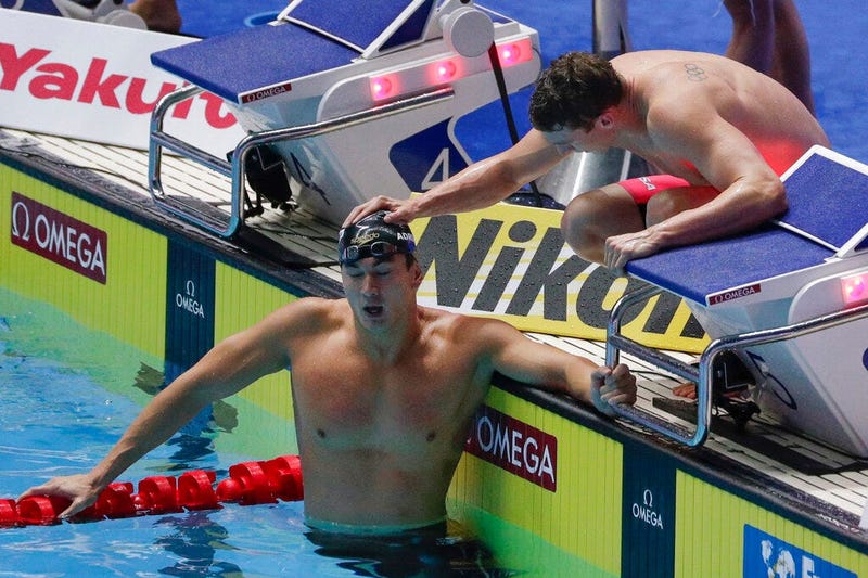 United States Nathan Adrian is consoled by a teammate after their second place finish in the men's 4x100m medley relay final at the World Swimming Championships in Gwangju, South Korea, Sunday, July 28, 2019
