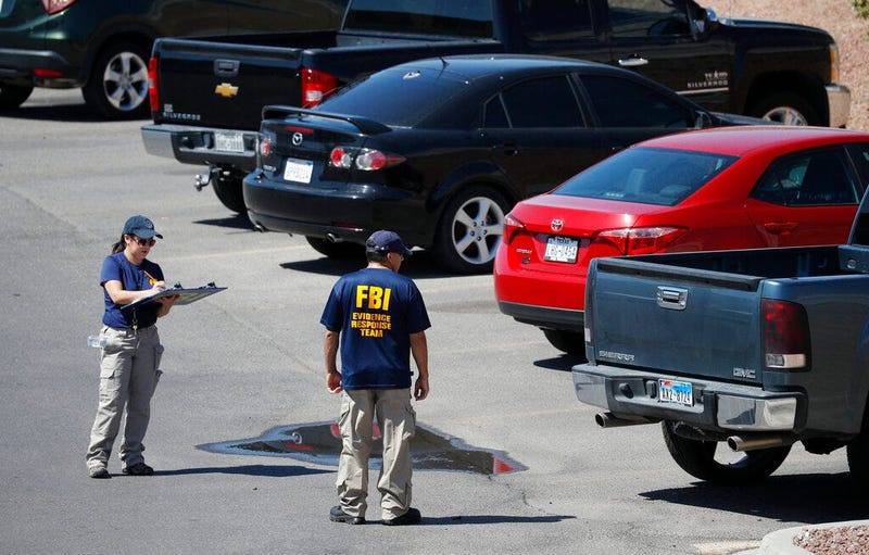 Members of the FBI evidence response team investigate the scene of a mass shooting at a shopping complex Sunday, Aug. 4, 2019, in El Paso, Texas.