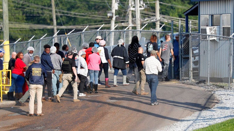 Workers exit this Koch Foods Inc.,