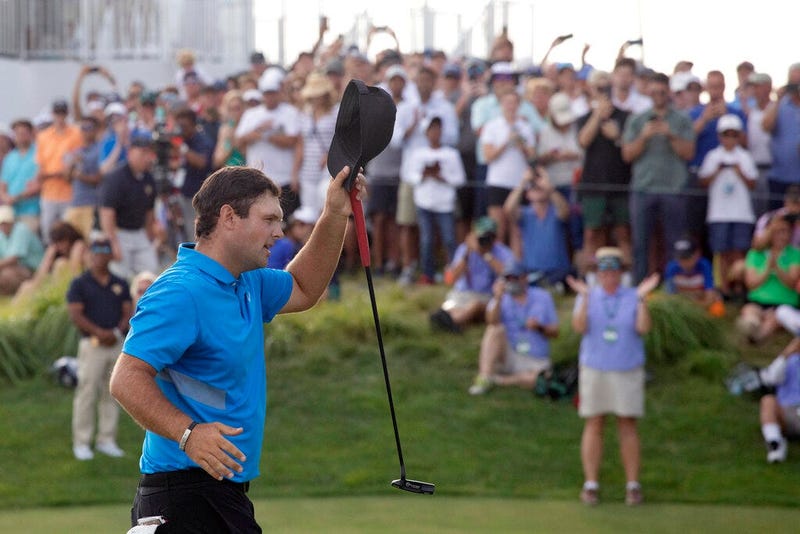 Patrick Reed tips his cap on the 18th hole as he wins on the Northern Trust golf tournament at Liberty National Golf Course, Sunday, Aug. 11, 2019, in Jersey City, N.J.