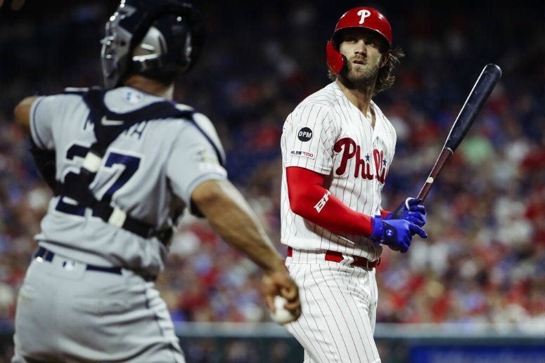 Philadelphia Phillies' Bryce Harper, right, looks up after striking out during the eighth inning of a baseball game against the San Diego Padres, Saturday, Aug. 17, 2019, in Philadelphia.