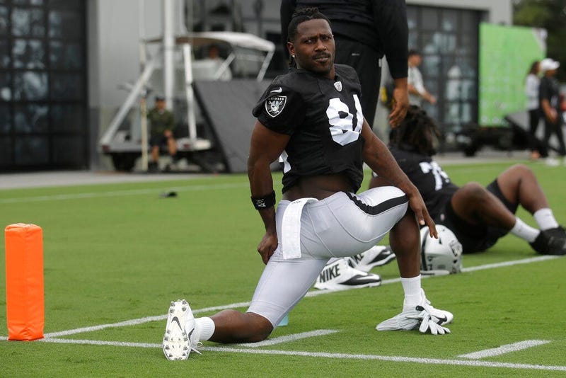 Oakland Raiders' Antonio Brown stretches during NFL football practice in Alameda, Calif., Tuesday, Aug. 20, 2019.