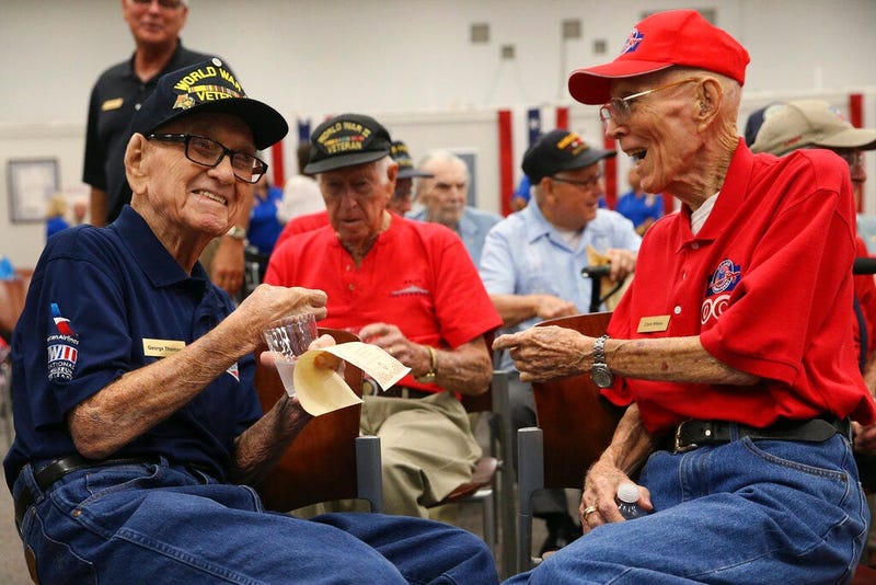 World War II veterans George Thomas, 97, left, and Clark Wilson, 93, enjoy conversation before a ceremony
