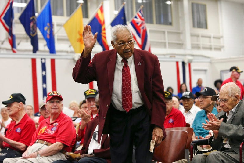 Tuskegee Airmen James L. Bynum, 98, waves as he is introduced during a ceremony at Joint Base San Antonio-Fort Sam Houston