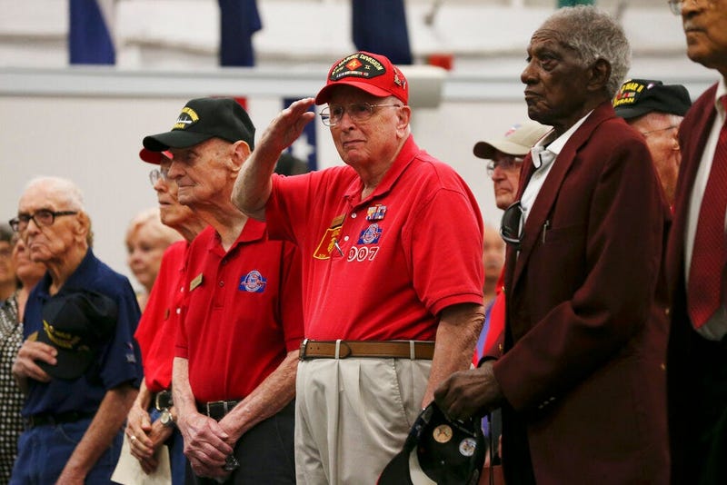 LeRoy Leonard, 93, salutes as the 323rd Army Band plays the U.S. military songs during a ceremony at Joint Base San Antonio-Fort Sam Houston