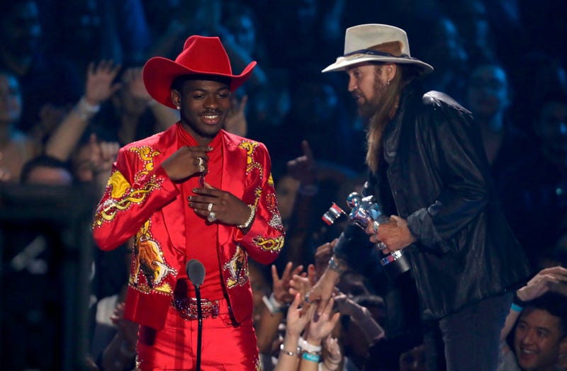 Lil Nas X, left, and Billy Ray Cyrus accept the song of the year award for "Old Town Road" at the MTV Video Music Awards at the Prudential Center on Monday, Aug. 26, 2019, in Newark, N.J.