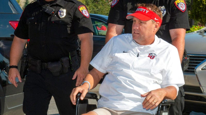 Liberty head football coach Hugh Freeze arrives to coach from a wheelchair in the coaches' box against Syracuse in an NCAA college football game in Lynchburg, Va., Saturday, Aug. 31, 2019.