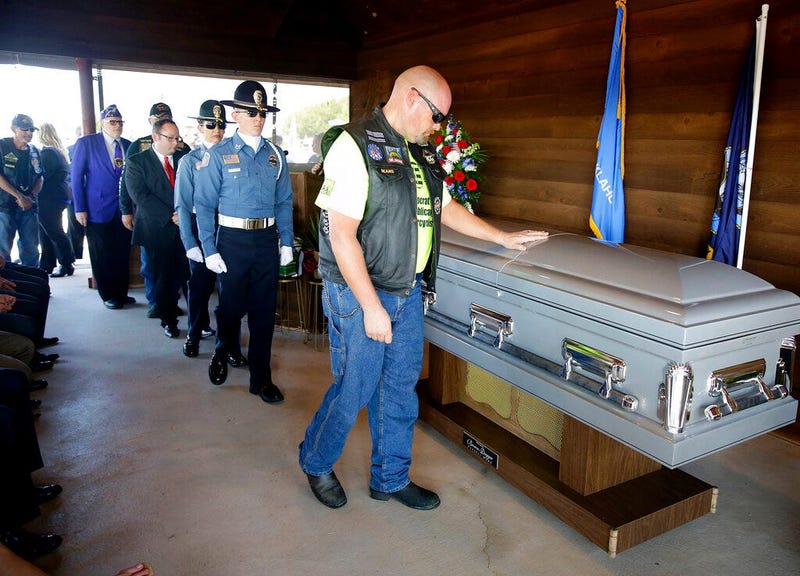 A mourner touches the casket of World War II veteran Herman White