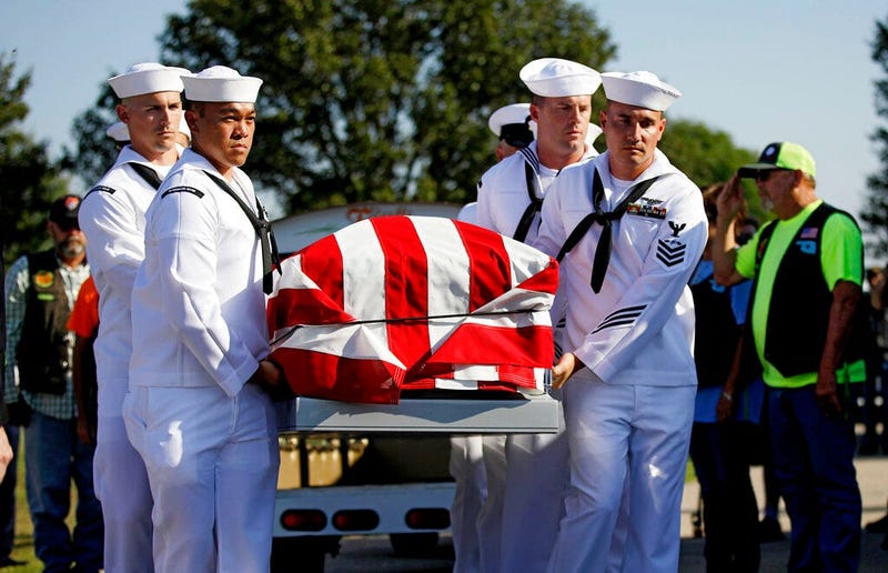 Sailors carry the casket of World War II veteran Herman White