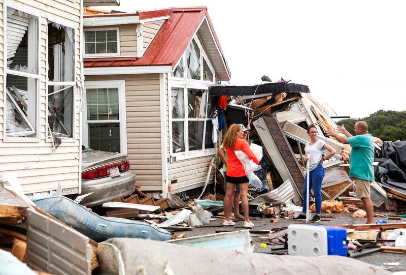Residents of the Boardwalk RV Park discuss the path of a possible waterspout or tornado, generated by Hurricane Dorian, struck the area, Thursday, Sept. 5, 2019, in Emerald Isle, N.C.