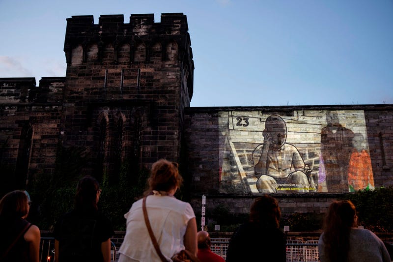 People view incarcerated filmmaker Robert's animated short titled "A Special Person" projected on the wall of Eastern State Penitentiary in Philadelphia.