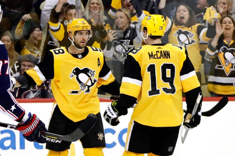 Pittsburgh Penguins' Kris Letang (58) celebrates his goal with Jared McCann during the second period of an NHL hockey game against the Columbus Blue Jackets in Pittsburgh, Saturday, Oct. 5, 2019.