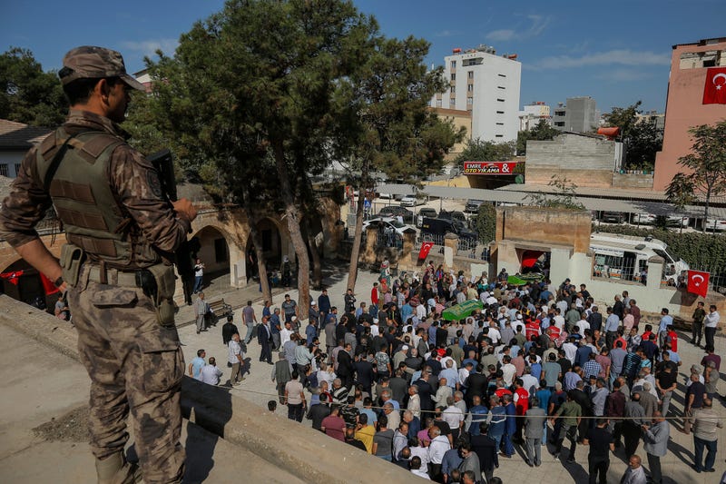 A Turkish soldier watches as mourners carry the coffins of Halil Yagmur, 64 and Muslum Guzel, killed Friday during mortar shelling from Syria, Saturday, Oct. 12, 2019