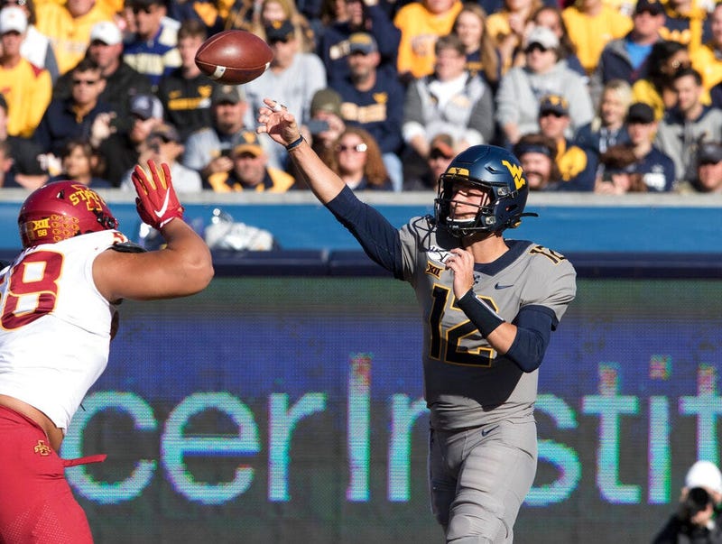 West Virginia quarterback Austin Kendall (12) attempts a pass during the first half of an NCAA college football game against Iowa State Saturday, Oct. 12, 2019, in Morgantown, W.Va.
