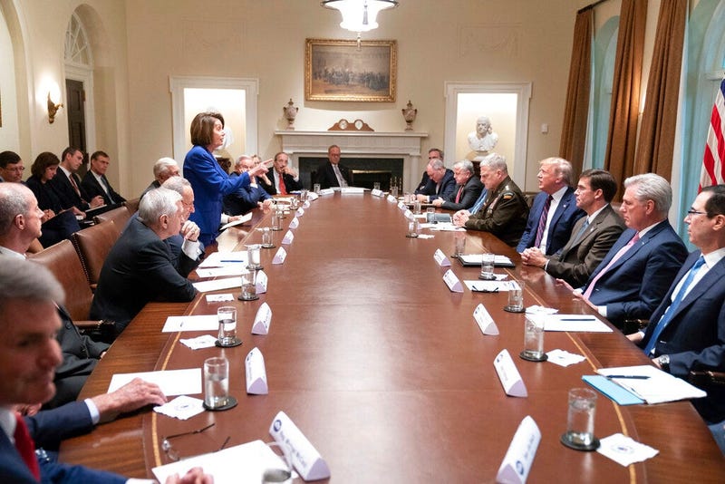 President Donald Trump, center right, meets with House Speaker Nancy Pelosi, standing left, Congressional leadership and others, Wednesday, Oct. 16, 2019, in the Cabinet Room of the White House in Washington.