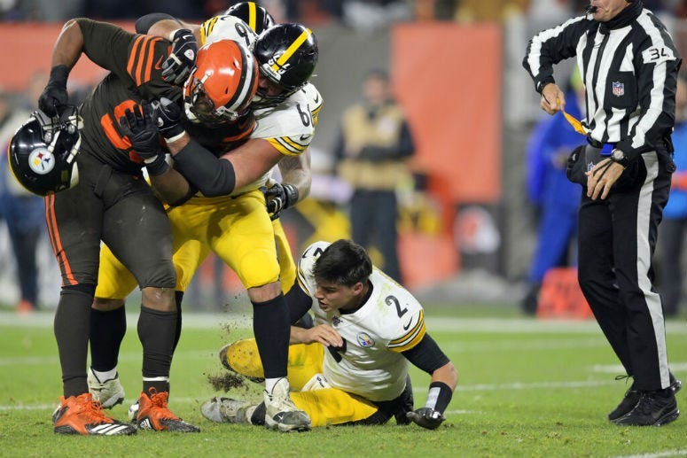Cleveland Browns defensive end Myles Garrett (95) takes Pittsburgh Steelers quarterback Mason Rudolph's (2) helmet off.
