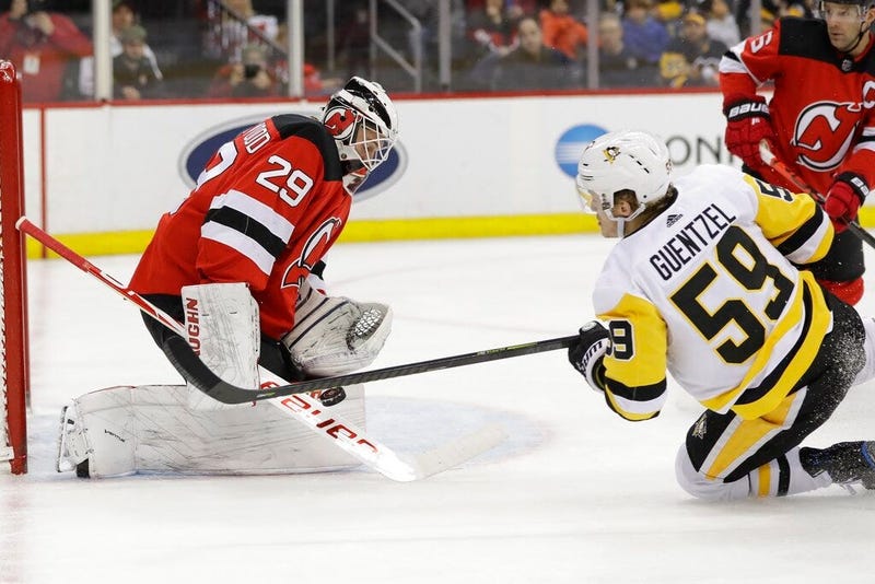 New Jersey Devils goaltender Mackenzie Blackwood (29) stops a shot by Pittsburgh Penguins' Jake Guentzel (59) during the first period of an NHL hockey game Friday, Nov. 15, 2019, in Newark, N.J.