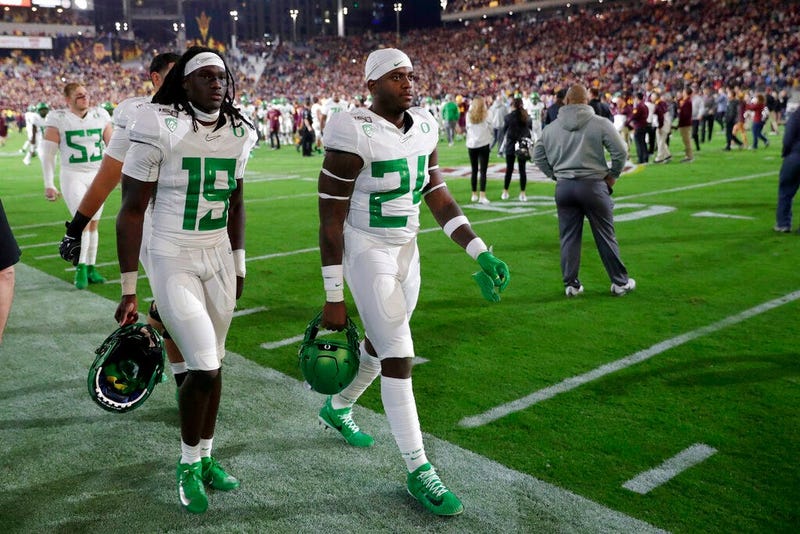 Oregon safety Jamal Hill (19) and linebacker Ge'mon Eaford leave the field after the team's NCAA college football game against Arizona State, Saturday, Nov. 23, 2019, in Tempe, Ariz. Arizona State won 31-28.