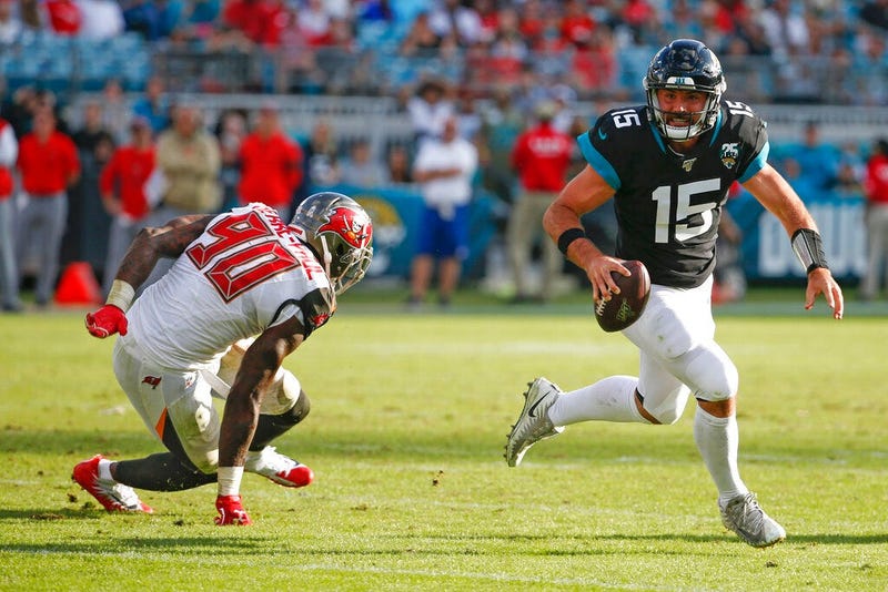 Jacksonville Jaguars quarterback Gardner Minshew (15) scrambles away from Tampa Bay Buccaneers linebacker Jason Pierre-Paul (90) during the second half of an NFL football game, Sunday Dec. 1, 2019, in Jacksonville, Fla.