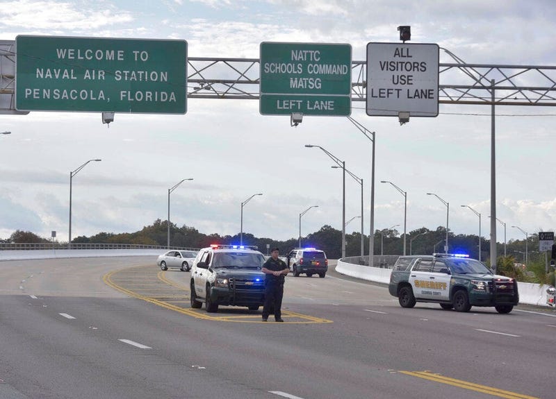 Police vehicles block the entrance to the Pensacola Air Base, Friday, Dec. 6, 2019 in Pensacola, Fla. The US Navy is confirming that a shooter is dead and several injured after gunfire at the Naval Air Station in Pensacola