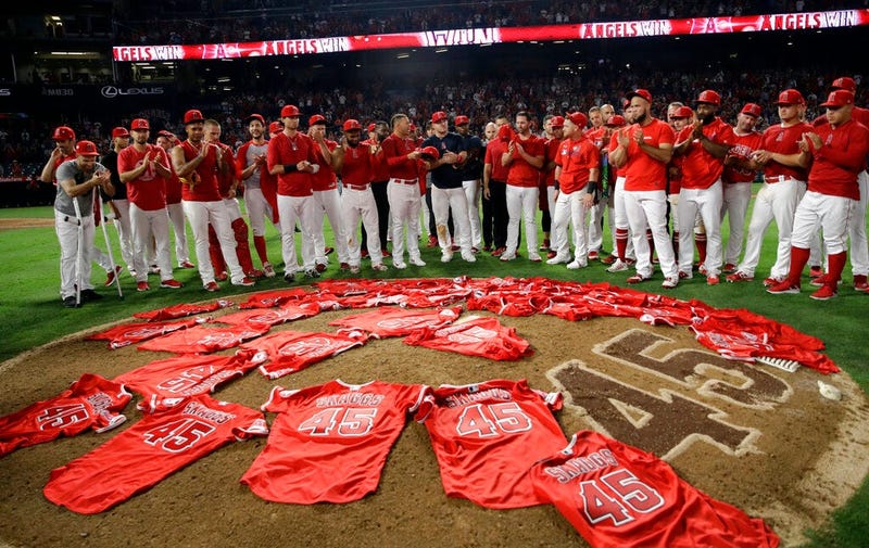 Members of the Los Angeles Angels place their jerseys with No. 45 in honor of pitcher Tyler Skaggs on the mound after a combined no-hitter against the Seattle Mariners during a baseball game, July 12, 2019, in Anaheim, Calif. 